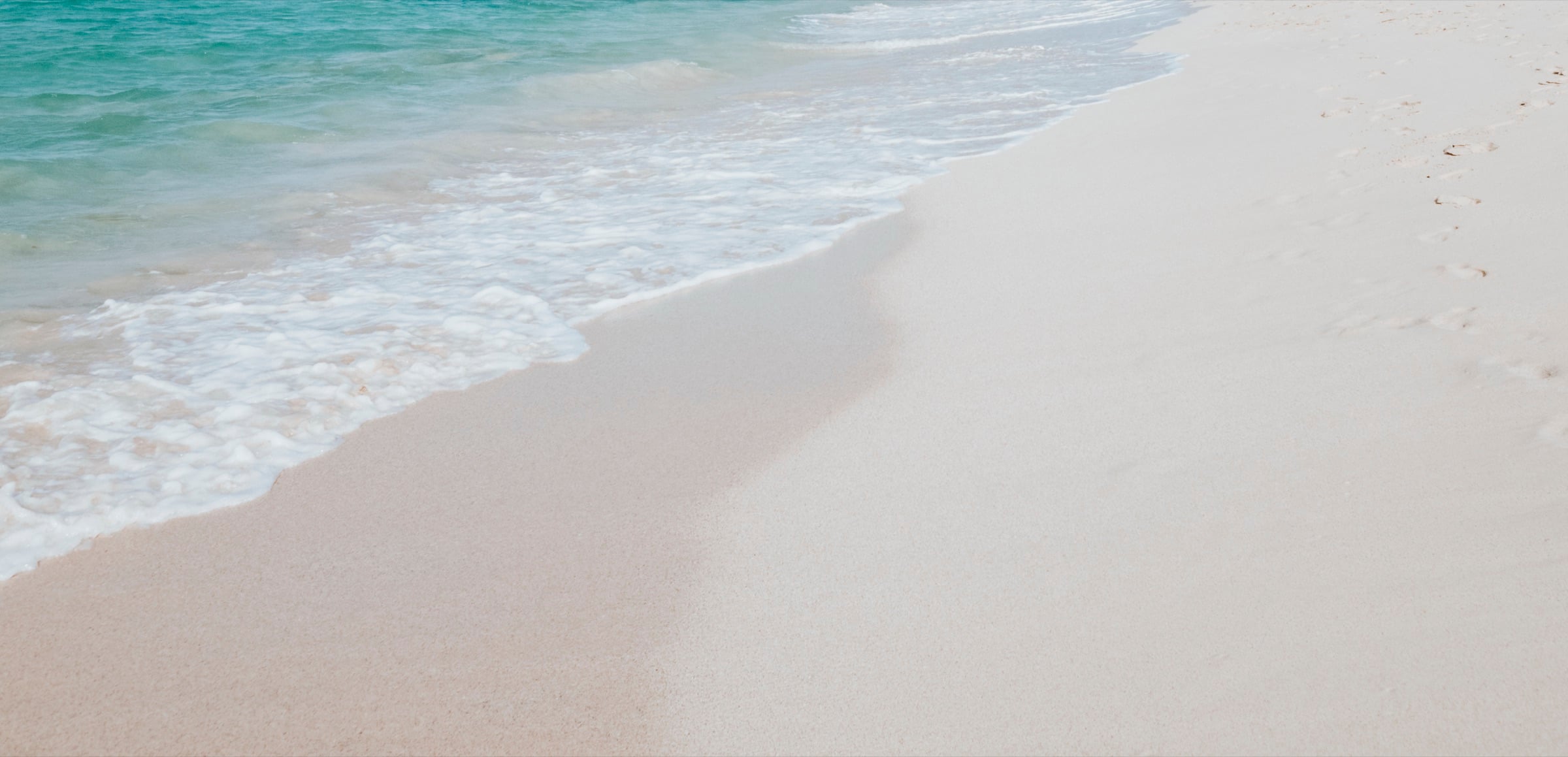 Gentle surf washing onto soft pale sand